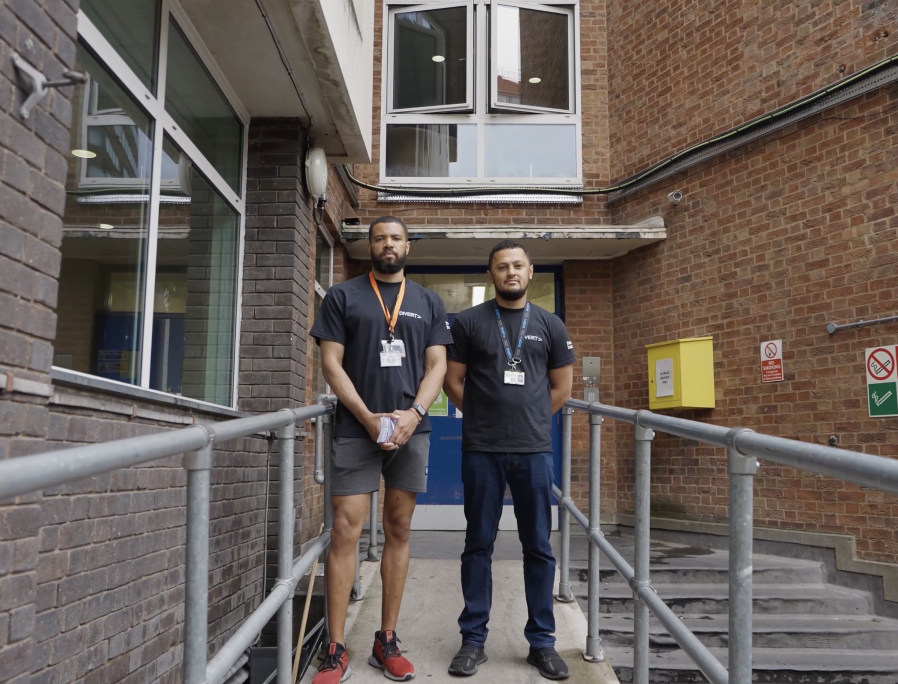 Image of two men on a stairwell from the DIVERT project. Shot by Rena Begum