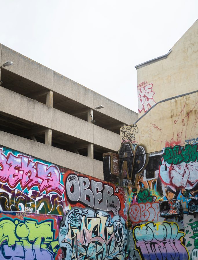 Street view of London buildings with heavy graffiti